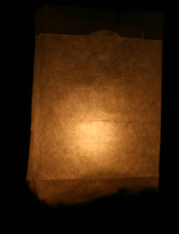 white bag with lit candle